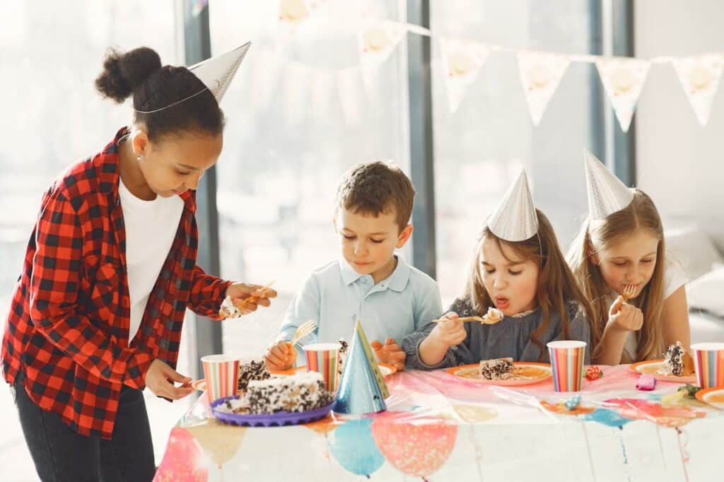 Foster children celebrating at a birthday party and eating birthday cake